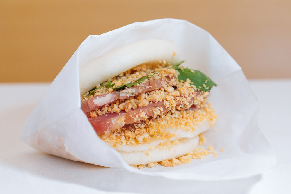 Roasted Berkshire Pork Belly Gwa Bao w togarashi aioli, pickled daikon radishes, cilantro, crushed peanut powder