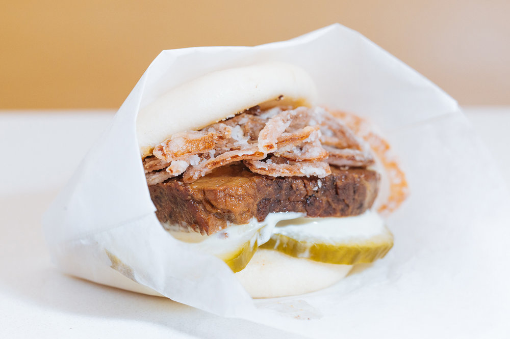 Slow-cooked Grassfed Beef Gwa Bao w garlic aioli, pickled cucumbers, crispy shallots